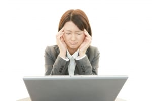 Young woman with both hands on her head, looking frustrated or thoughtful, How to Stop Seeking Approval